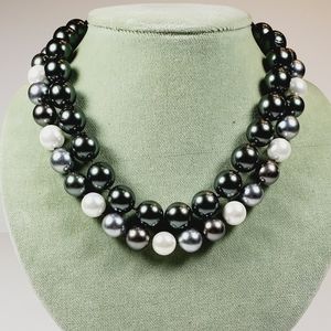 Pair of faux South Sea Peal necklaces with pave set clasps.